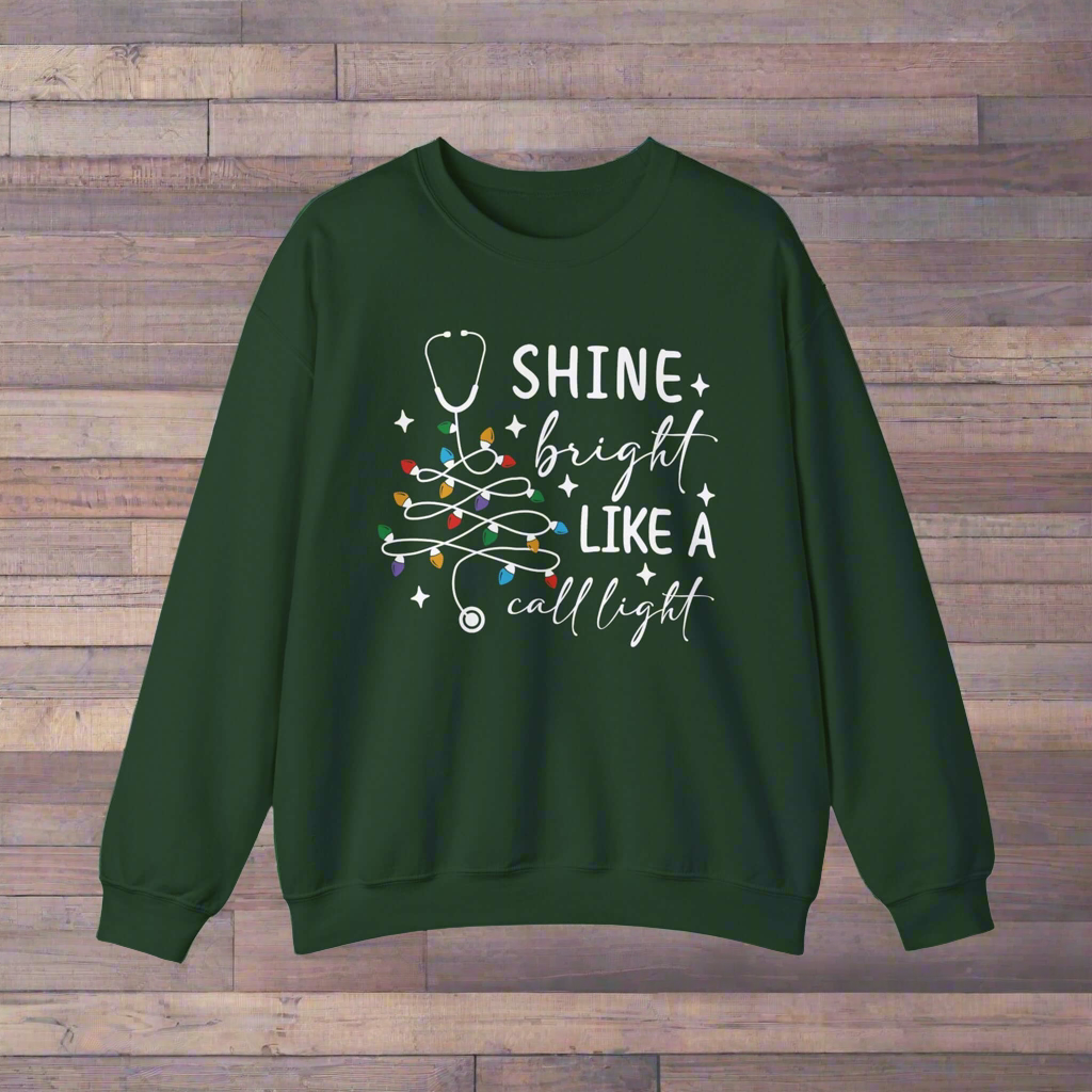 Shine Bright Like a Call Light Christmas Nurse Sweatshirt – Unisex Cozy Stethoscope Tree Crewneck for Healthcare Workers