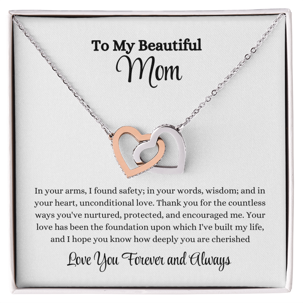 Interlocking Hearts Necklace in rose gold and yellow gold with sparkling CZ crystals, displayed with heartfelt message card: "In your arms, I found safety..." – perfect gift for mom, wife, or daughter