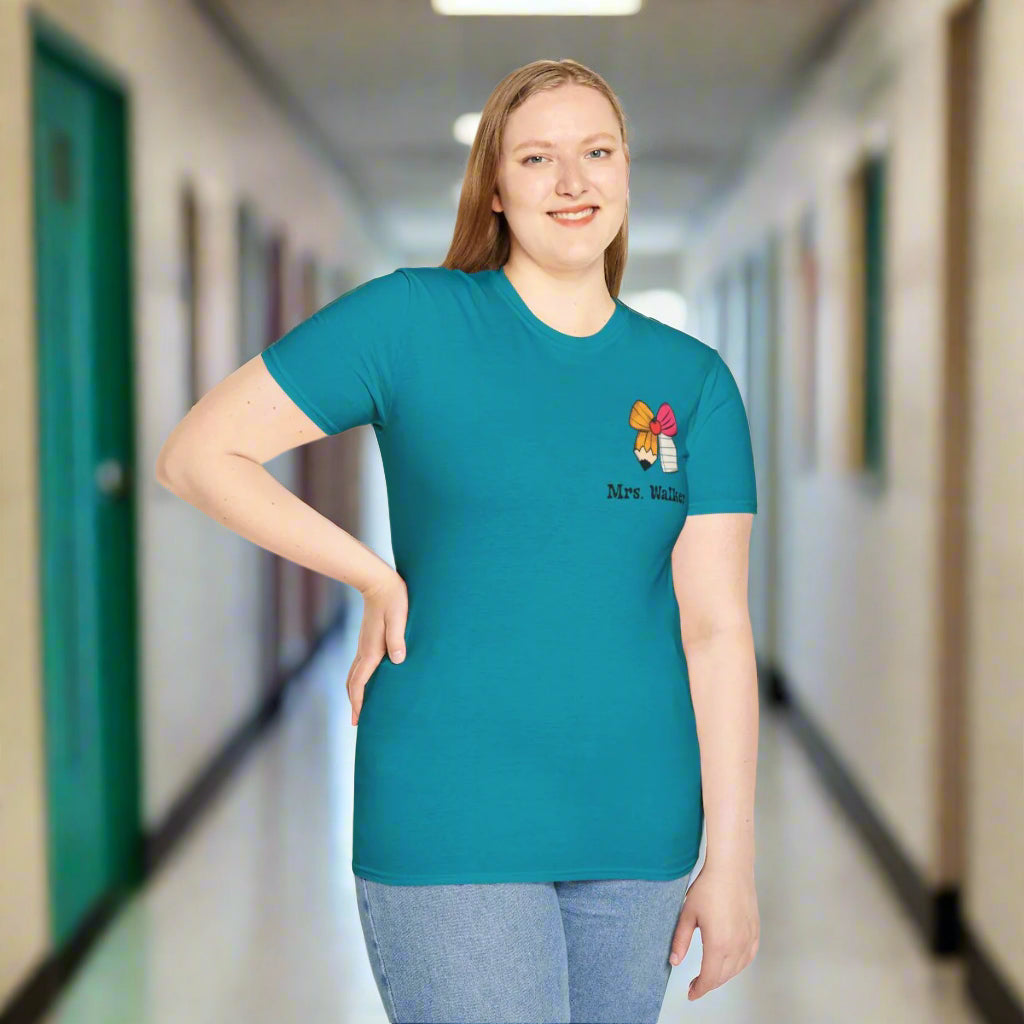 Person wearing a teal t-shirt with a logo and text on a white background