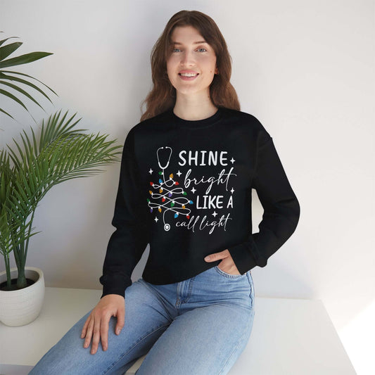 Shine Bright Like a Call Light Christmas Nurse Sweatshirt – Unisex Cozy Stethoscope Tree Crewneck for Healthcare Workers