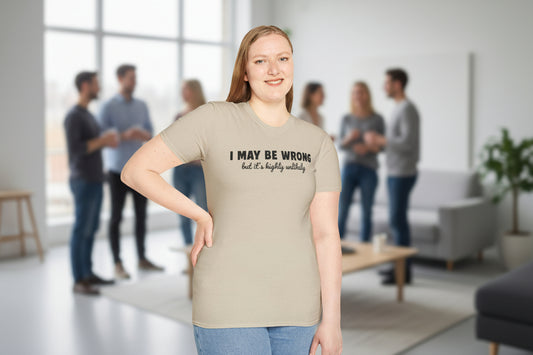 Woman wearing beige crewneck t-shirt with "I May Be Wrong But It's Highly Unlikely" text print in black letters, soft ring-spun cotton fabric, casual office setting, funny sarcastic humor statement tee, comfortable everyday wear