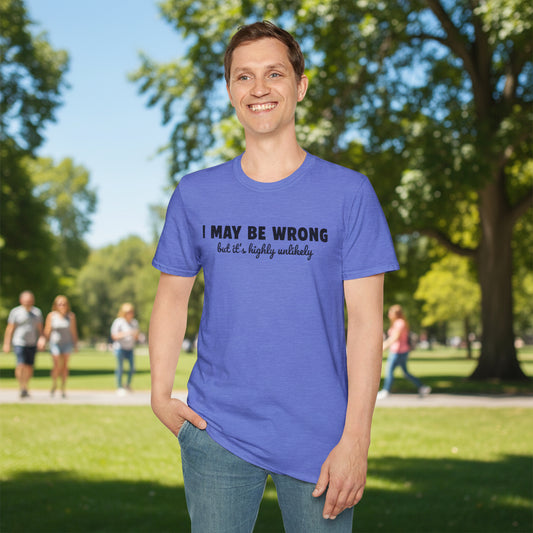 Man wearing a heather blue Gildan Softstyle 64000 unisex t-shirt in a park, printed with the funny slogan "I May Be Wrong But It's Highly Unlikely" in bold and script text