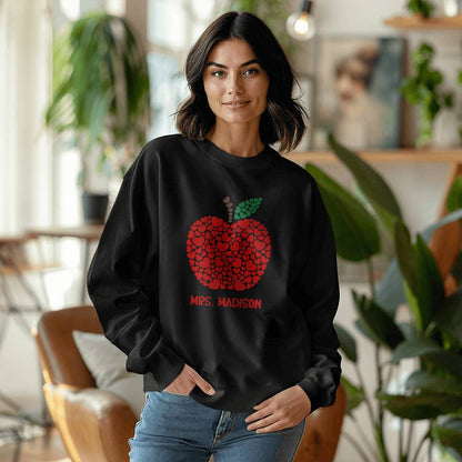 Personalized teacher apple sweatshirt with custom name printed on a black unisex crewneck, cozy Gildan 18000 fleece, perfect teacher gift