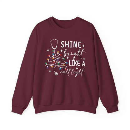 Shine Bright Like a Call Light Christmas Nurse Sweatshirt – Unisex Cozy Stethoscope Tree Crewneck for Healthcare Workers