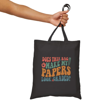 Black tote bag with two straps. It has the phrase “Does this bag make my papers look graded?”