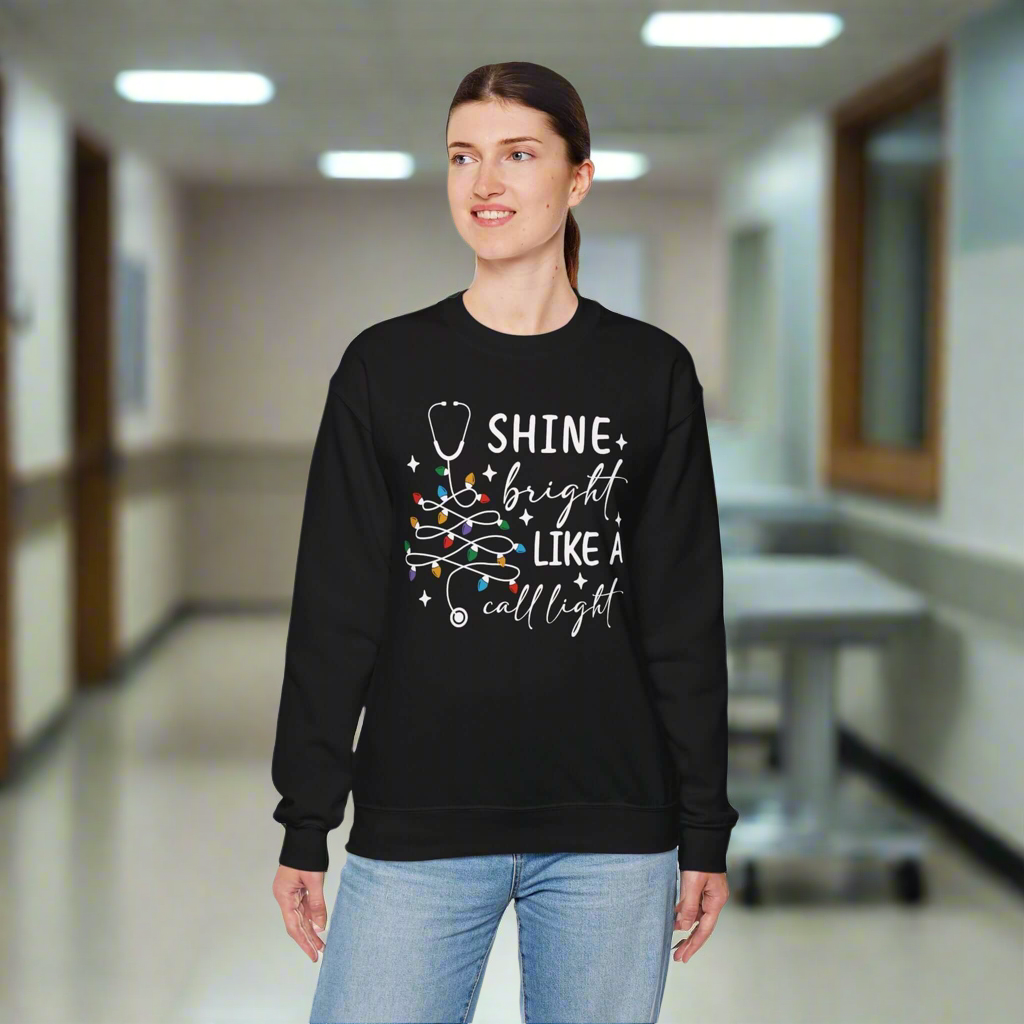 Shine Bright Like a Call Light Christmas Nurse Sweatshirt – Unisex Cozy Stethoscope Tree Crewneck for Healthcare Workers