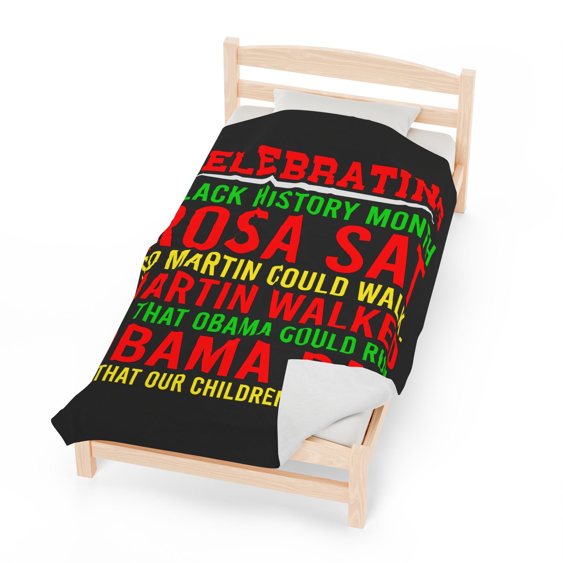 Large blanket with a black backgroup with red, green, and yellow writing: Celebrating Back History Month : Rosa Sat so Martin could walk Martin walked that Obama could run Obama ran So that our children could fly