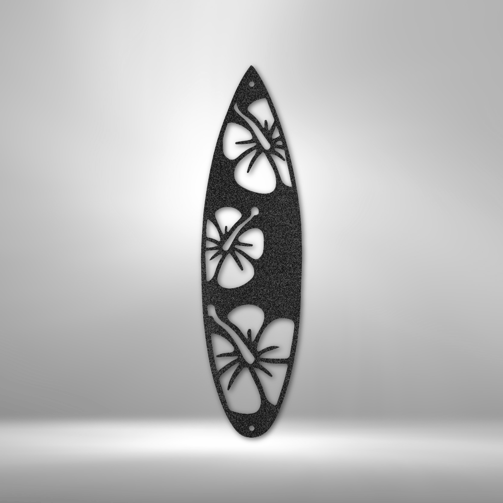 Black steel surfboard-shaped wall art with laser-cut hibiscus flowers, perfect for tropical or coastal home decor indoors or outdoors.