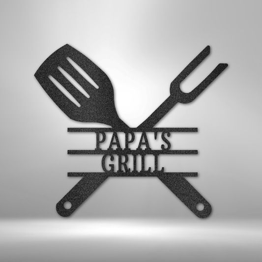 Black powder coated personalized laser cut metal grill master sign featuring crossed spatula and fork with custom name text, for outdoor BBQ and patio wall decor