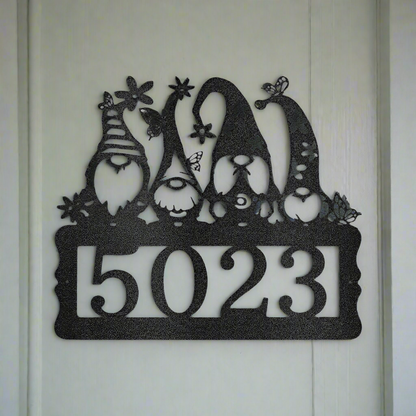 Custom gnome metal address sign with personalized house numbers, laser-cut from black powder-coated 16-gauge steel, displayed on exterior house wall for outdoor home décor.