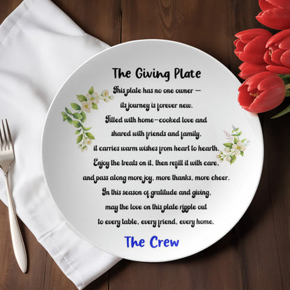 Personalized white ceramic Giving Plate with heartfelt sharing poem and delicate floral design, customized with "The Crew" in blue text, displayed on rustic wooden table with red tulips and white napkin