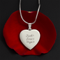 Engraved heart necklace with Faith Love Hope inscription on polished stainless steel pendant displayed on a red rose, featuring an adjustable snake chain and personalized engraving option