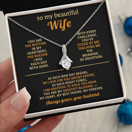 Alluring Beauty ribbon-shaped pendant necklace with a sparkling cubic zirconia stone displayed in a gift box for a wife.