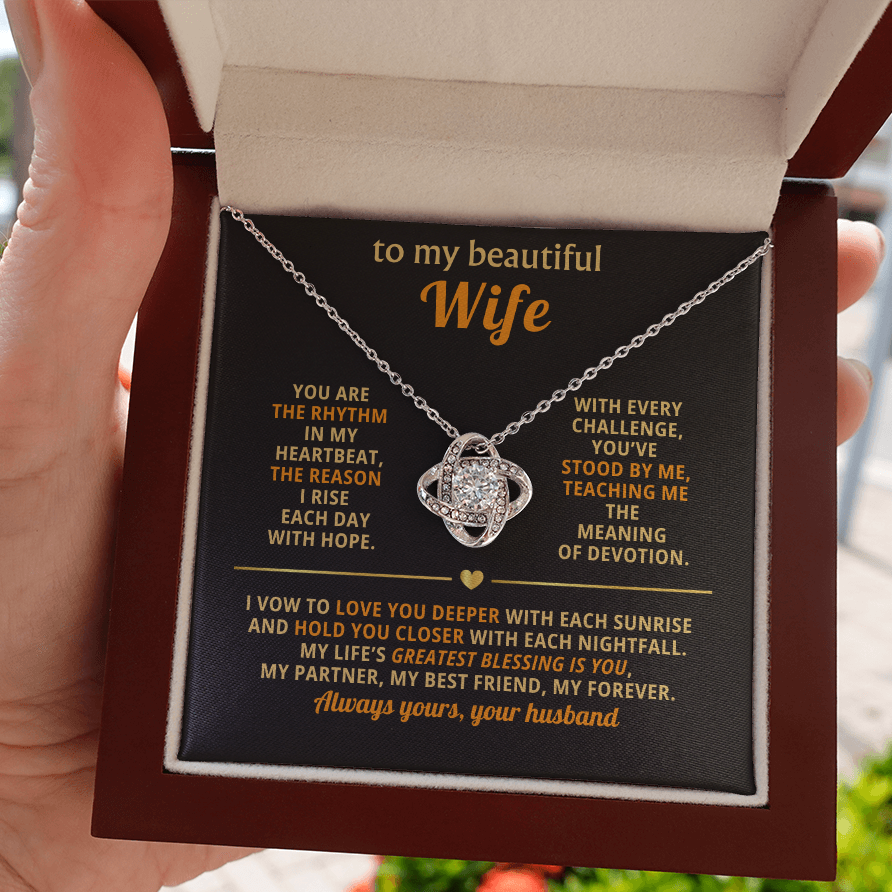 Close-up image of a Love Knot Necklace with a 6mm cubic zirconia center stone and adjustable chain, symbolizing an unbreakable bond.