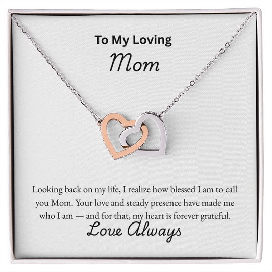 Interlocking Hearts Necklace for Mom with CZ crystal pendants in rose gold and silver finish, displayed in a white gift box with sentimental "To My Loving Mom" message card — perfect Mother's Day or birthday jewelry gift.