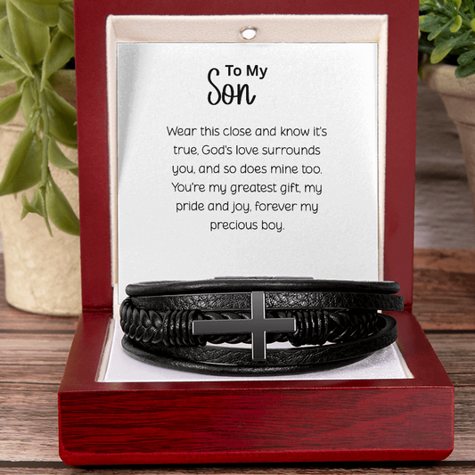 Black braided leather men's bracelet with stainless steel cross displayed in red mahogany gift box with "To My Son" inspirational message card on wooden table