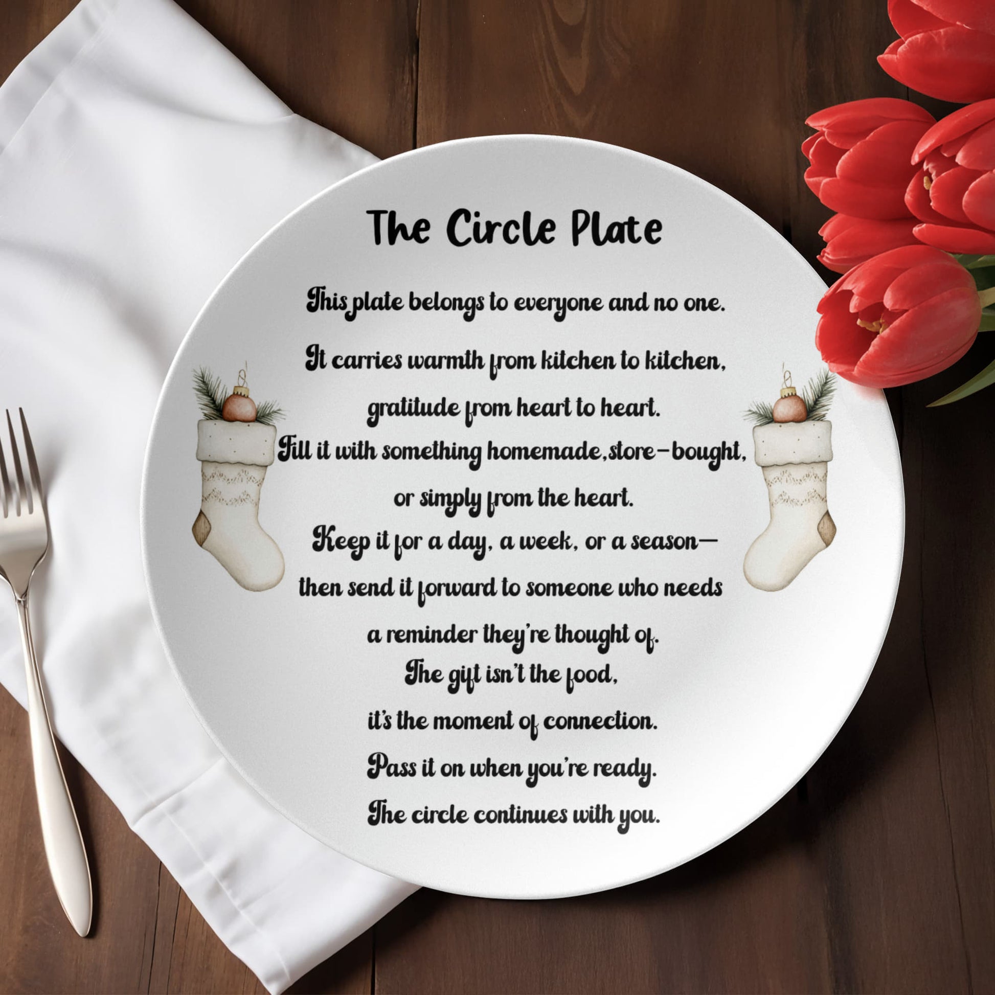 “The Circle Plate with heartfelt message about sharing gratitude and connection, featuring festive stockings design, displayed on a wooden table with red tulips.”