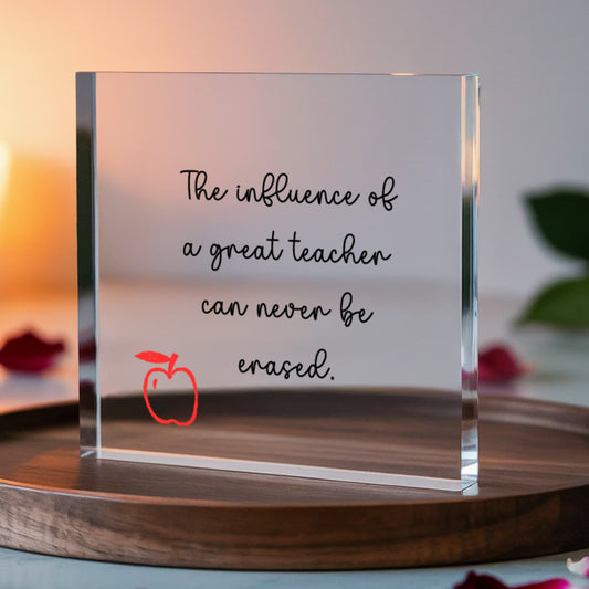Clear acrylic block displaying inspirational teacher quote "The influence of a great teacher can never be erased" with red apple icon, 6x6 inch premium teacher appreciation gift for desk or shelf display