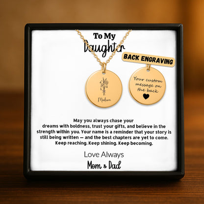 Personalized gold disc necklace for daughter in a black gift box, featuring a custom name and birth flower engraving on the front and a laser-engraved message on the back, from Mom and Dad — available in 18k gold, rose gold, and stainless steel.